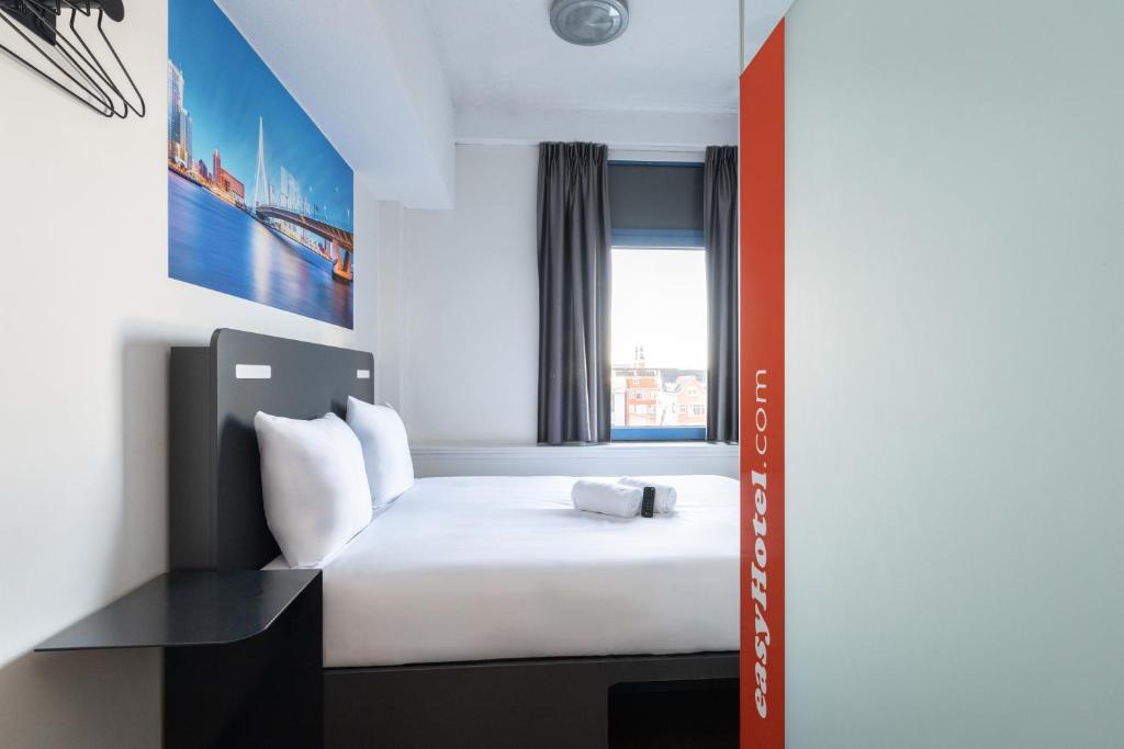 a small room with a bed and a window at easyHotel Rotterdam City Centre in Rotterdam