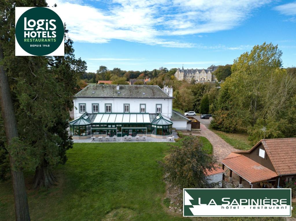 an aerial view of a large white building with a yard at Logis - Hotel Restaurant La Sapinière in Wisques