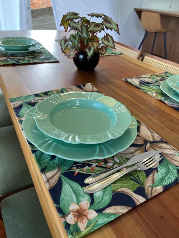 帕圖布蘭科的住宿－Villa Regina，一张木桌,上面有盘子和餐具