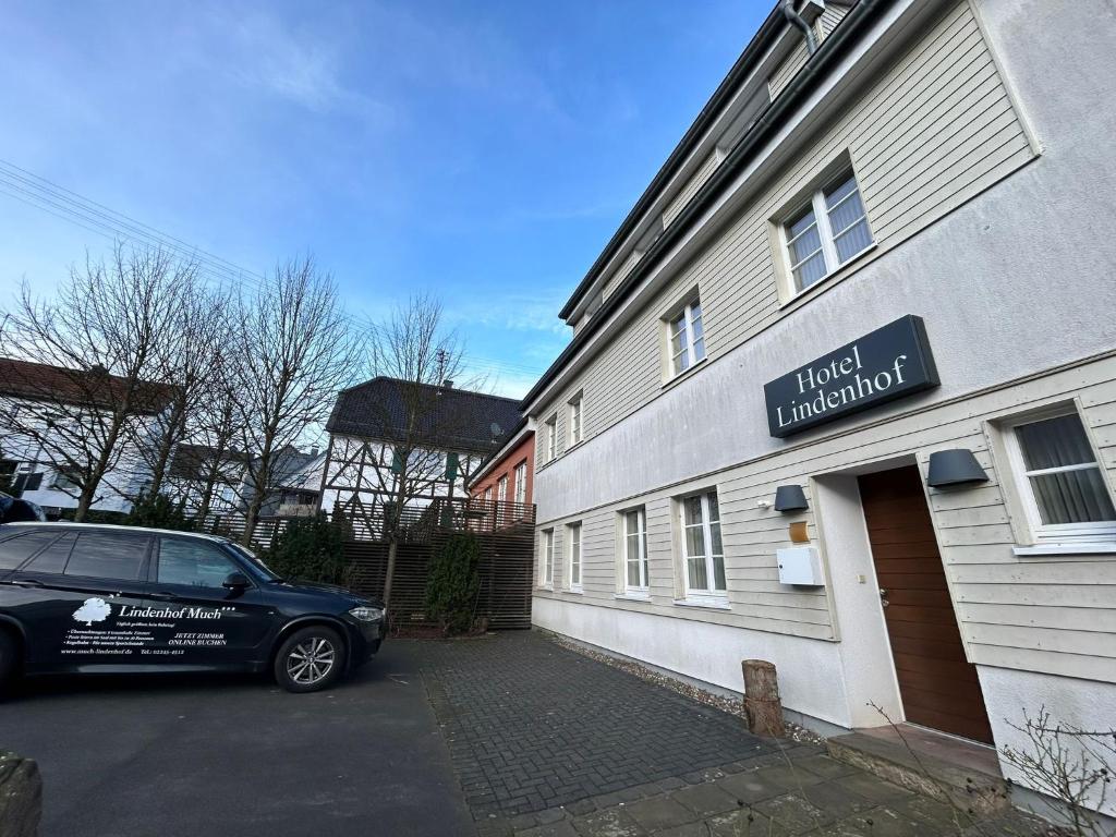 a car parked in front of a building at Gasthaus Lindenhof in Much