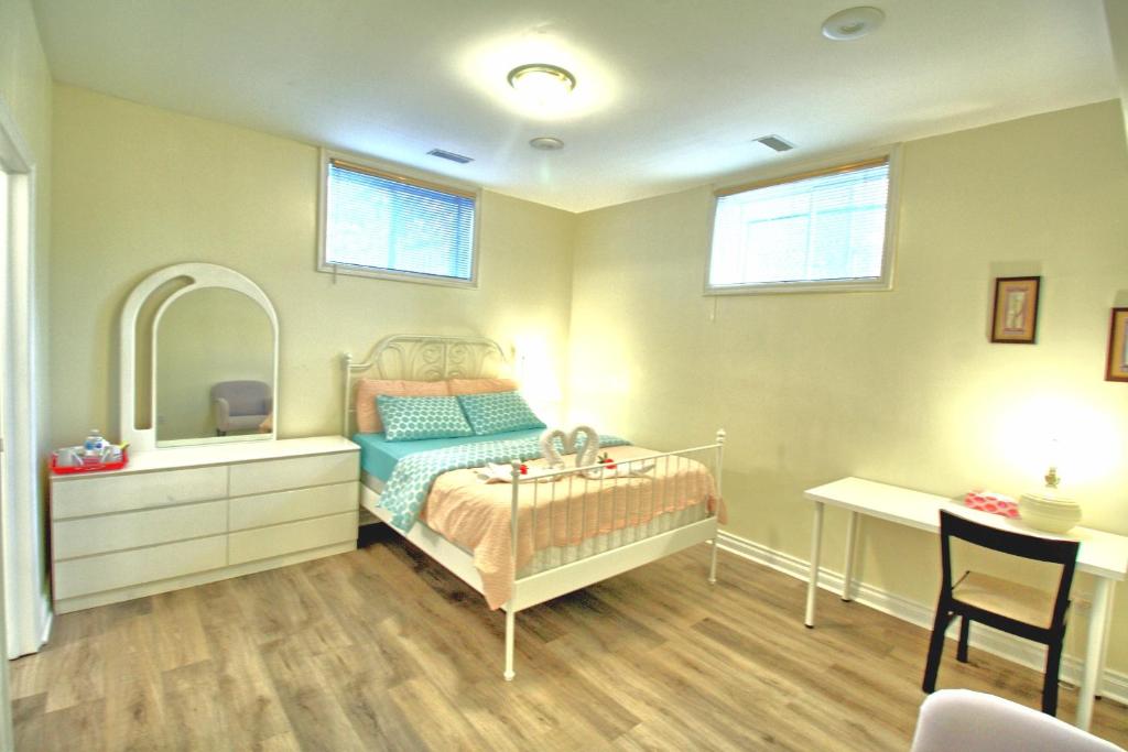 a bedroom with a bed and a mirror and a desk at Free Parking Private Bathroom on Basement in Vaughan