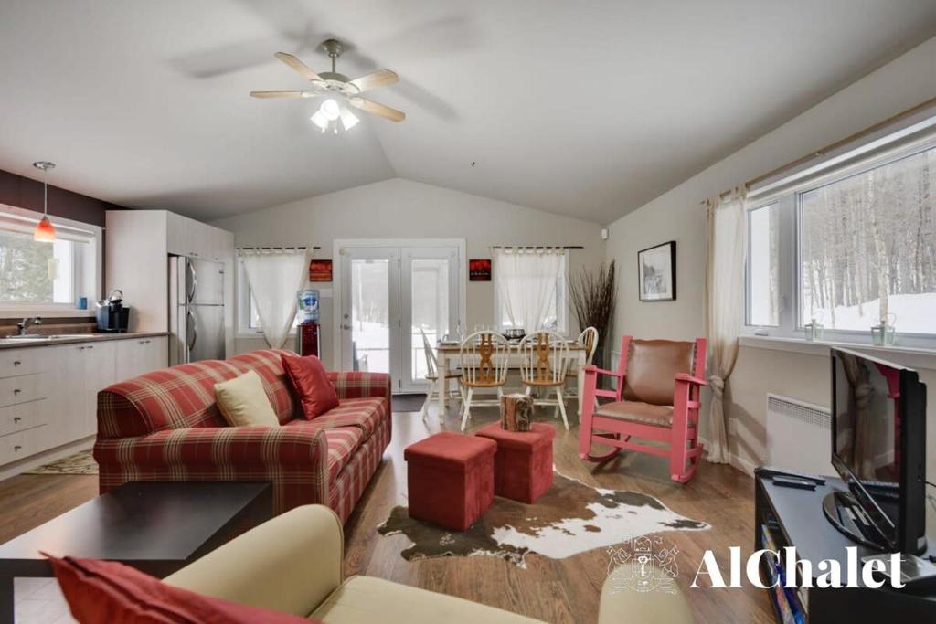 a living room with a couch and a table at Un coin pour deux in Saint-Raymond