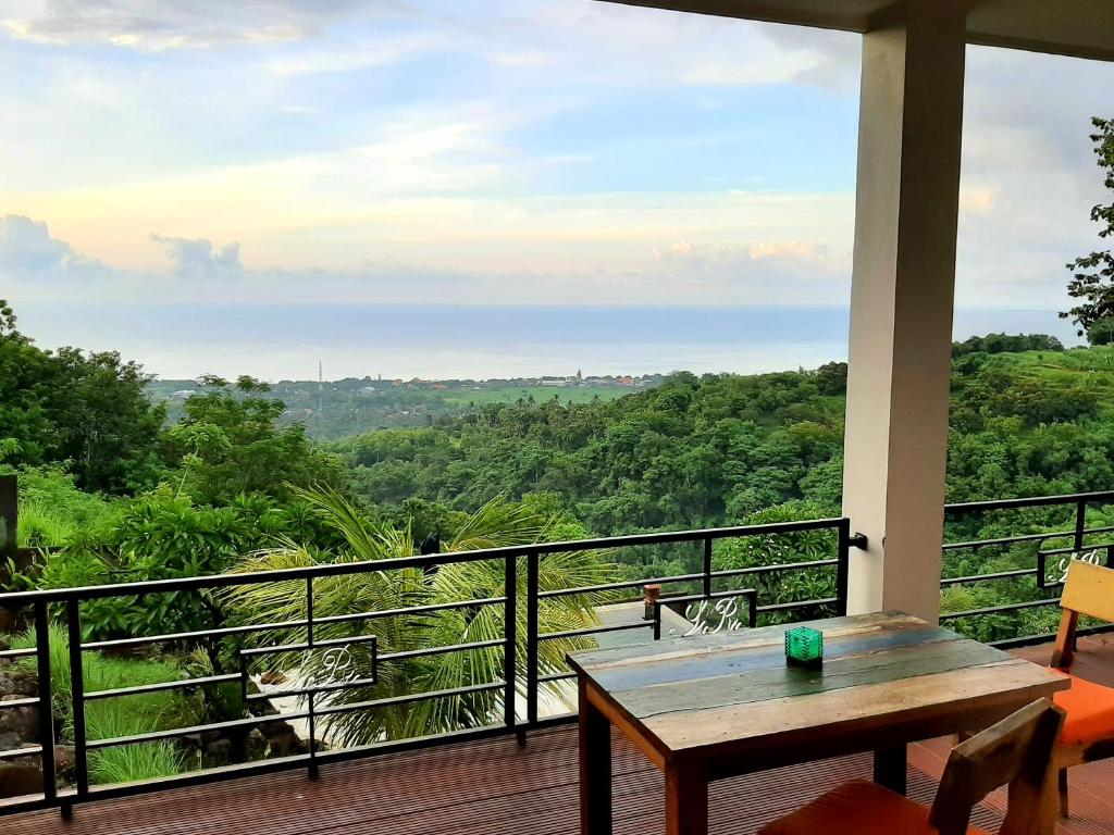 a porch with a table and a view of the forest at Private Villa - Ocean, hills, valley view in Temukus