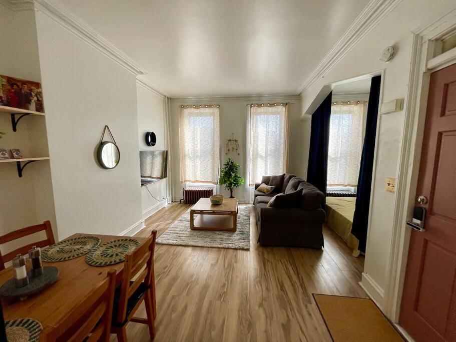 a living room with a table and a couch at Walk everywhere! Stylish apartment for up to 5 in Albany