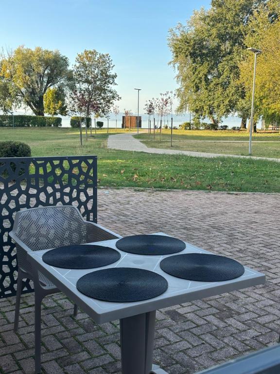 a bench with a table in a park at Zamárdi Parti Apartman 1 in Zamárdi