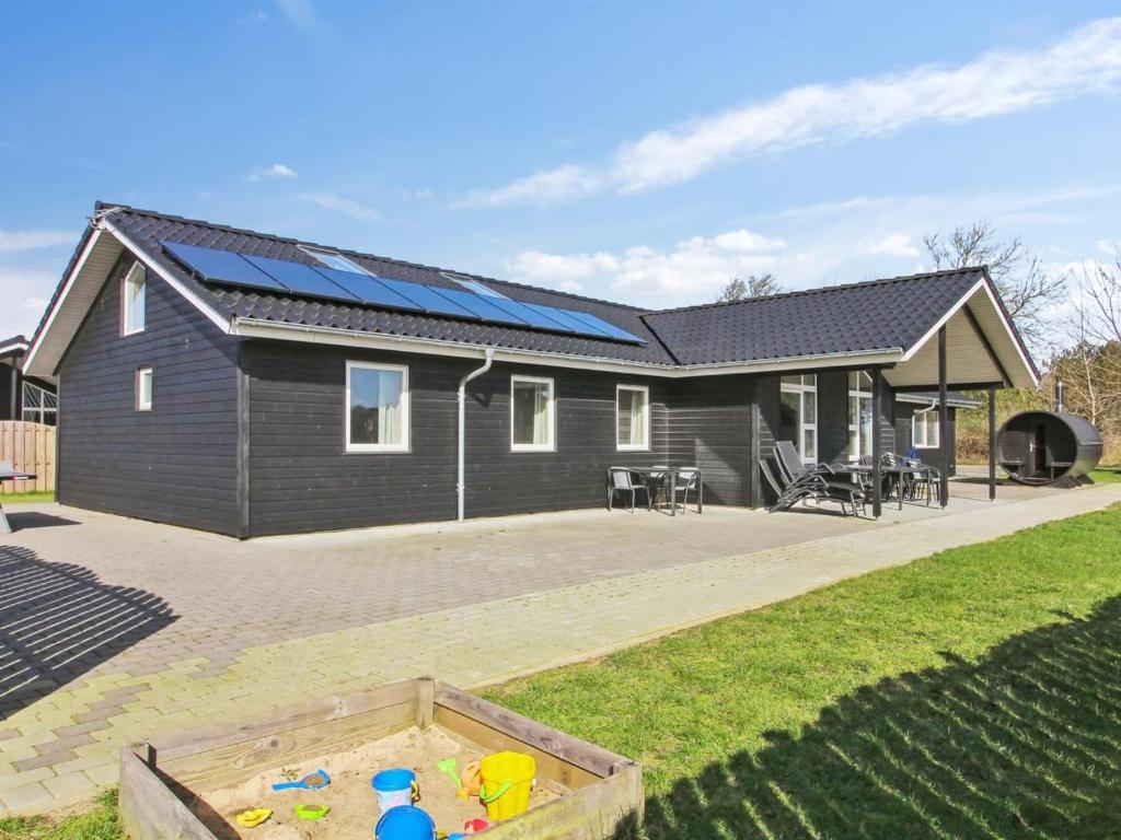a house with solar panels on the roof at Holiday Home Eilen - all inclusive - 3-3km from the sea by Interhome in Rømø Kirkeby