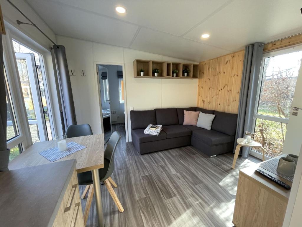 a living room with a couch and a table at Holiday Home Tiny Haus Marion by Interhome in Riedenburg