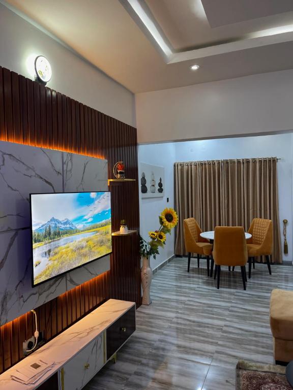 a living room with a tv and a table at Havmoorehomes Ltd in Port Harcourt