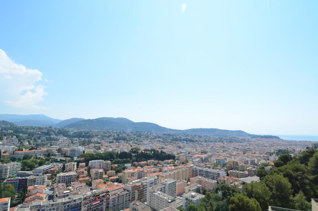 an aerial view of a city with buildings at Appartement vue panoramique avec piscine pour 6 personnes &agrave; Nice quartier Pessicart in Nice