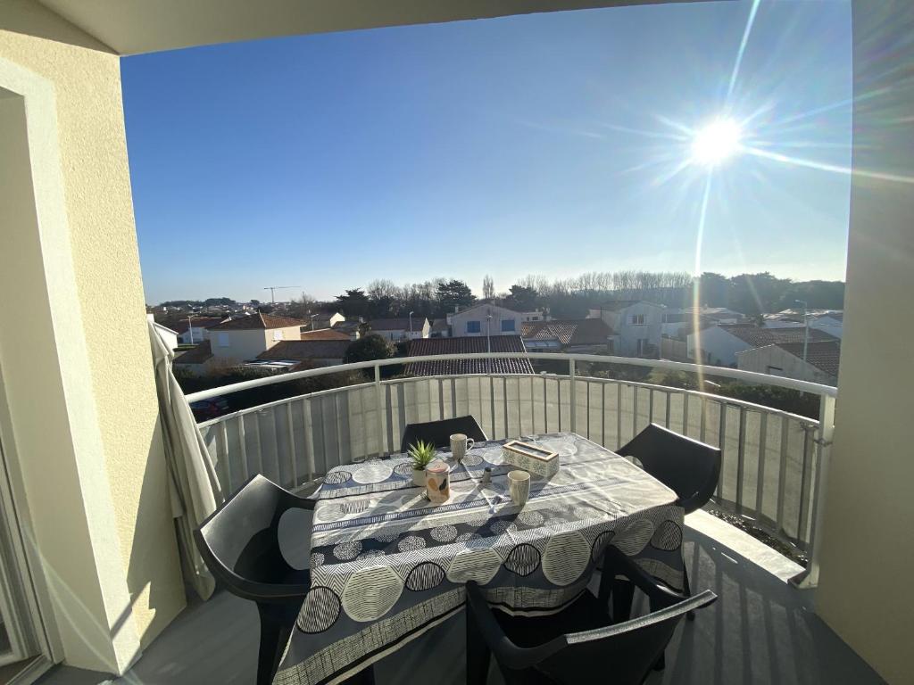 - une table sur un balcon avec vue sur la ville dans l'établissement L Oyat, à Saint-Gilles-Croix-de-Vie