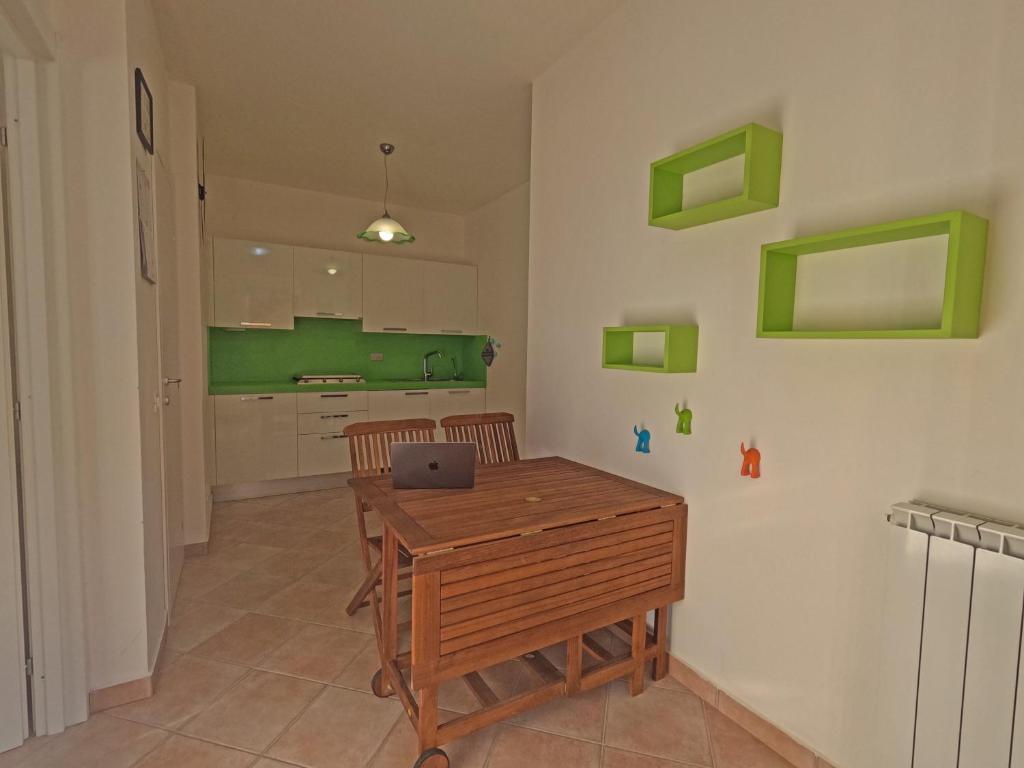 a kitchen with a wooden table with a laptop on it at Hotel Villa Argentina in Riomaggiore