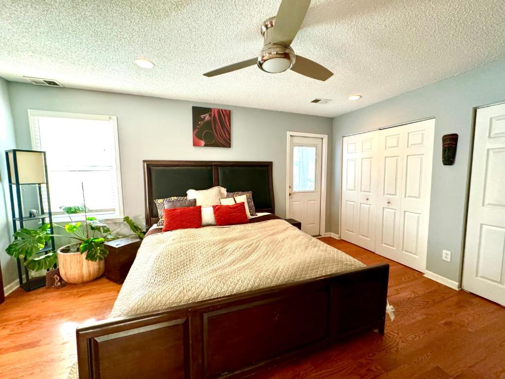 a bedroom with a large bed with red pillows at African Zen Oasis in Atlanta