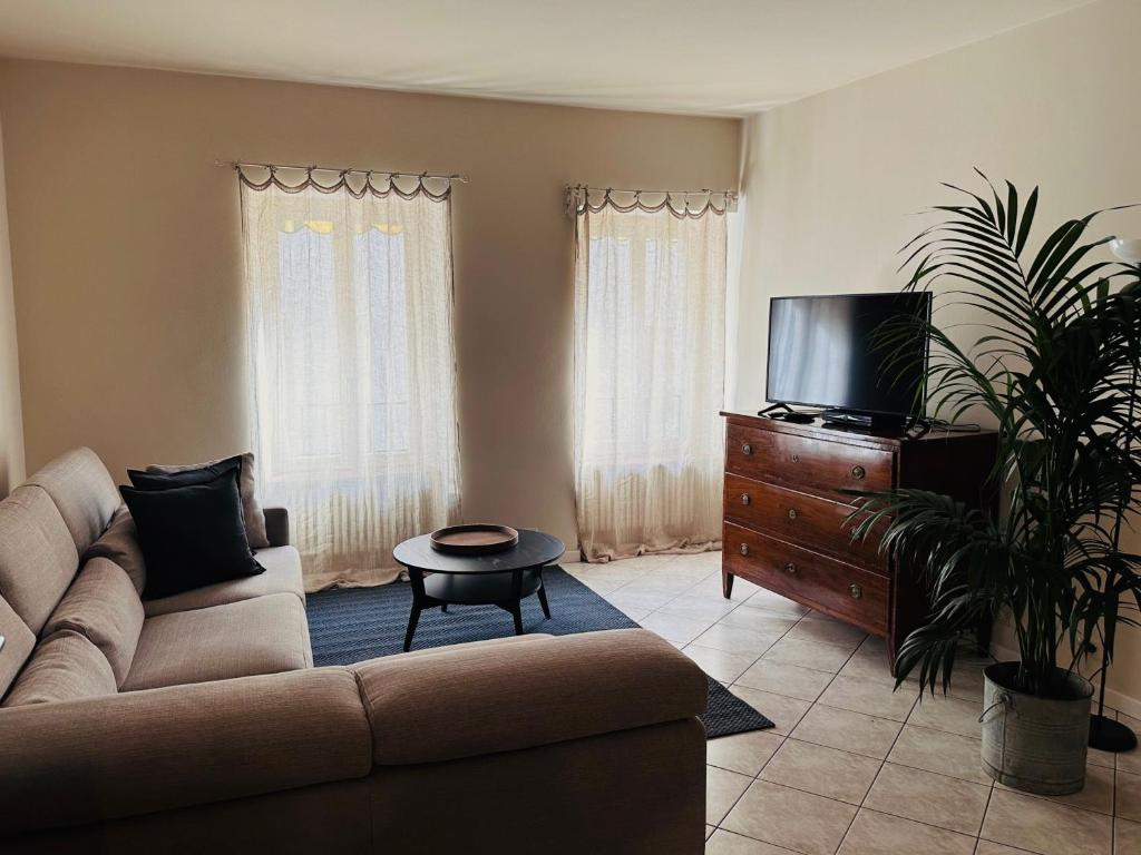 een woonkamer met een bank en een flatscreen-tv bij Holiday Home Curt de l'Elba with private garden and parking - Cernobbio in Cernobbio