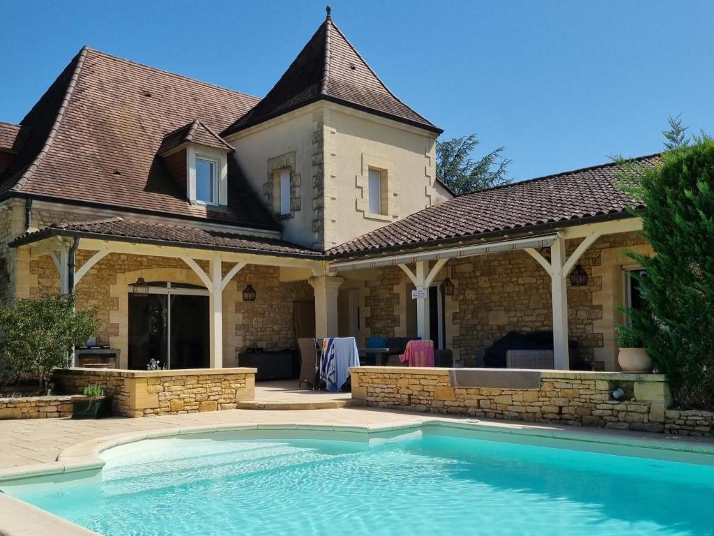 ein Haus mit einem Swimmingpool davor in der Unterkunft La Grange Sud in Turnac