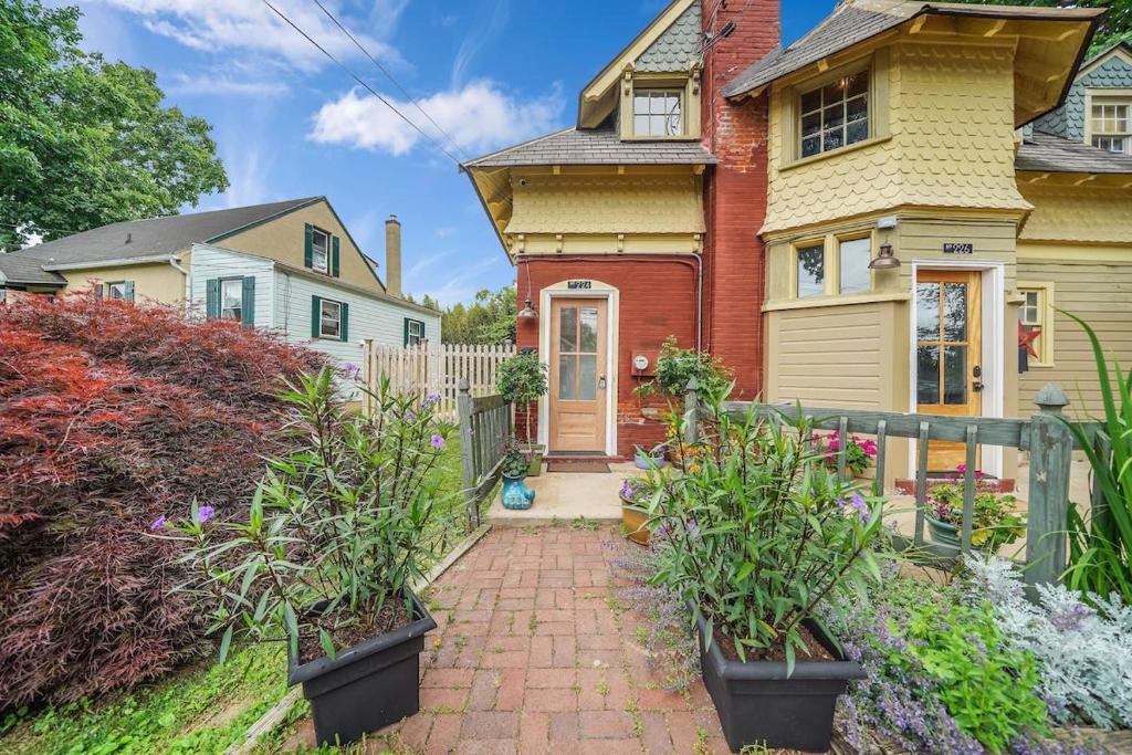 a house with a brick pathway leading to the front door at Luxury Loft in Historic Carriage House in Kennett Square