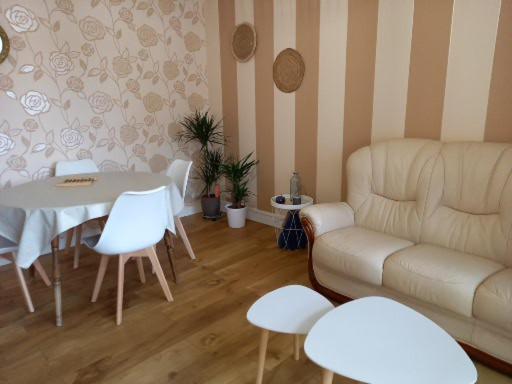 a living room with a couch and a table at ANDISE in Courseulles-sur-Mer