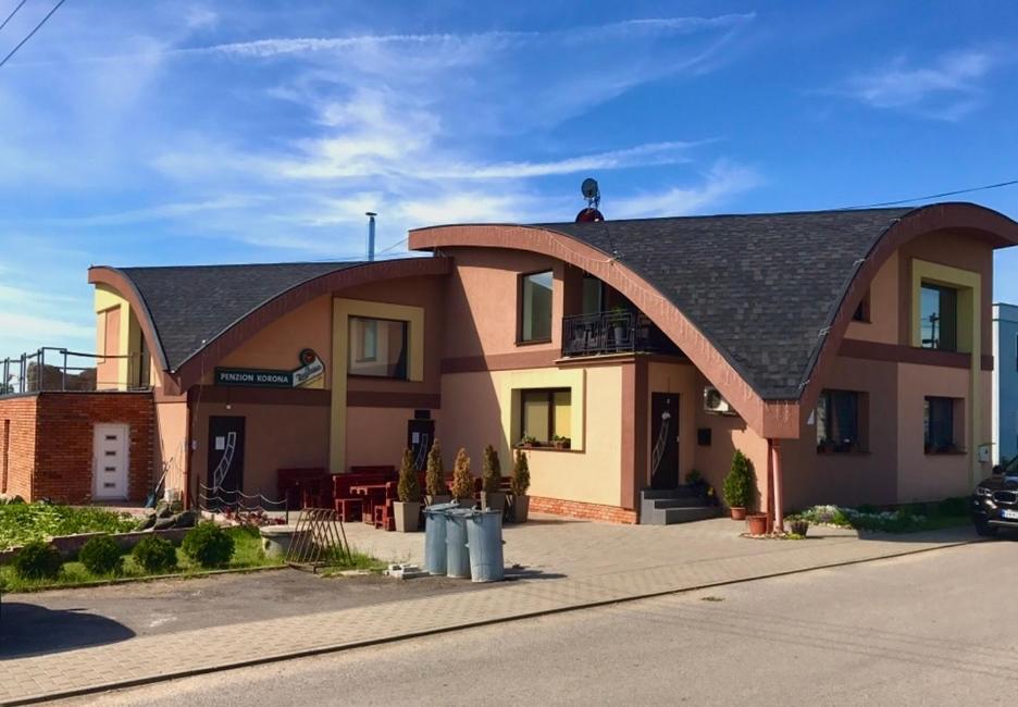 a large house with a gambrel roof at Korona Panzió in Blh nad Ipľom