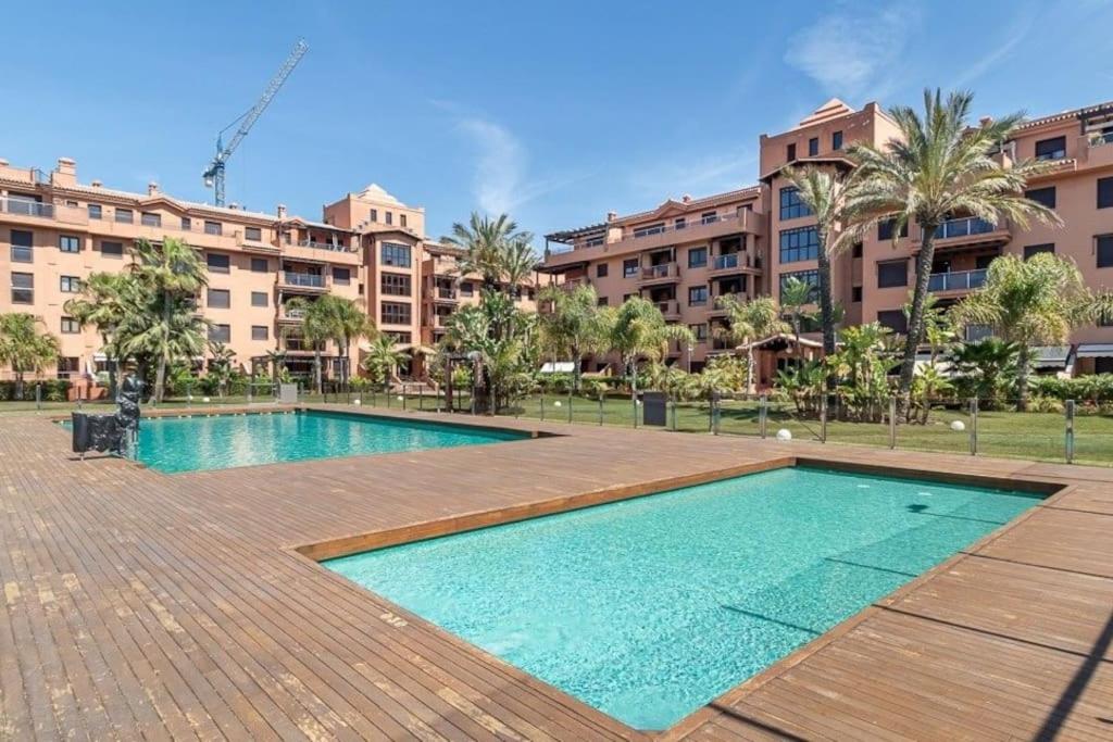 een zwembad voor een groot gebouw bij Candela Beach Luxury Apartament in Motril