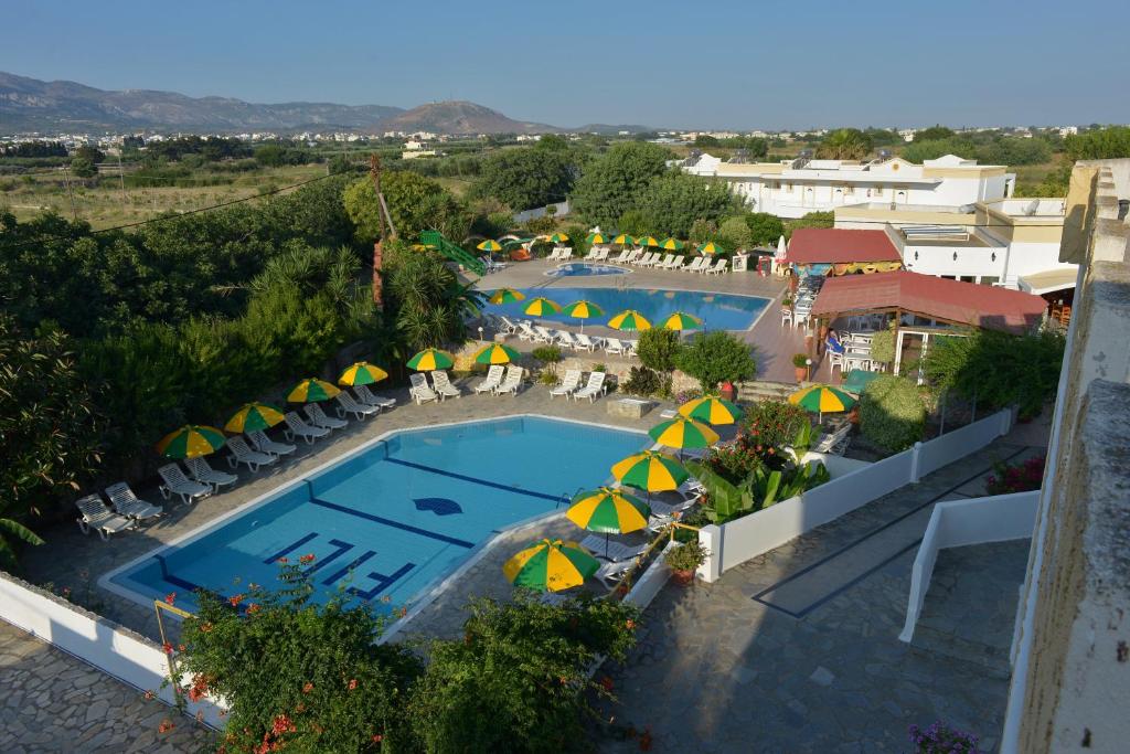 an aerial view of a resort with a pool and umbrellas at Fili Hotel Apartments in Tigaki