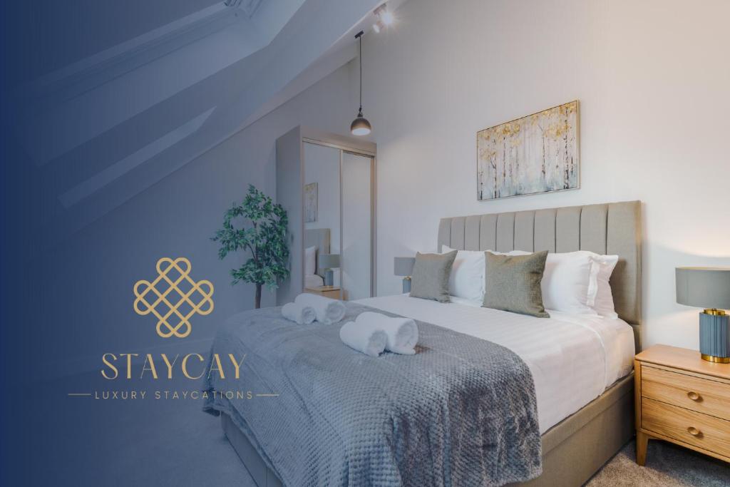 a bedroom with a bed with two stuffed animals on it at No.44 - Deluxe 2-Bedroom Duplex with Balcony in Stoney Middleton