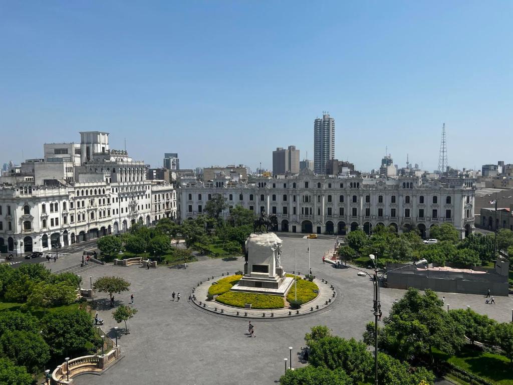 a large plaza with a statue in the middle of a city at Terrace Plaza Historic in Lima