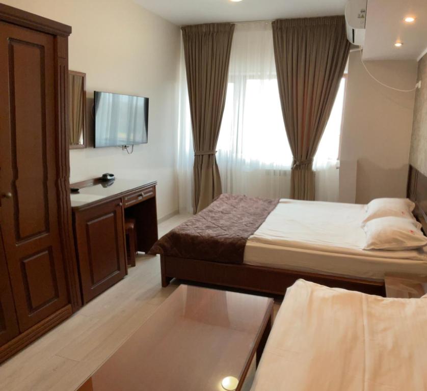 Postel nebo postele na pokoji v ubytování Hotel Ana