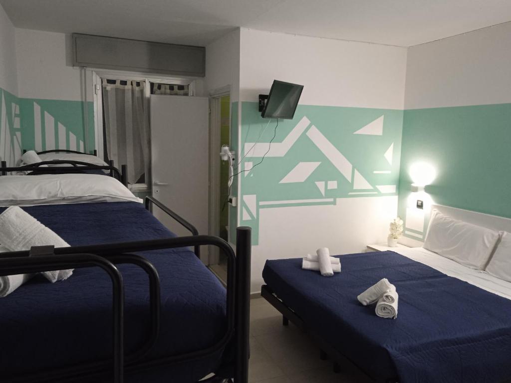 Postel nebo postele na pokoji v ubytování Hotel Napoleon