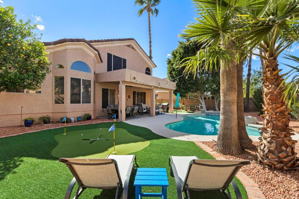 a house with a putting green with chairs and a golf ball at Scottsdale Casa del Sol- North Scottsdale with Private Pool, Hot Tub, Putting Green and More! in Phoenix