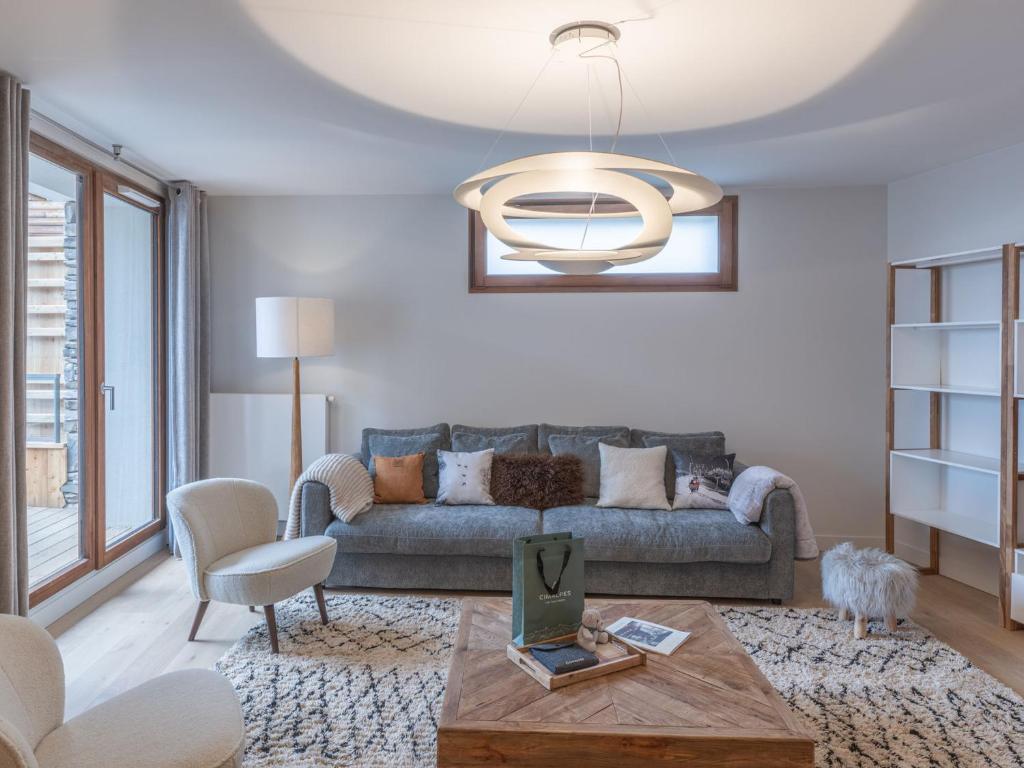 a living room with a couch and a table at Duplex neuf proche pistes avec Wifi et parking - FR-1-645-58 in LʼHuez