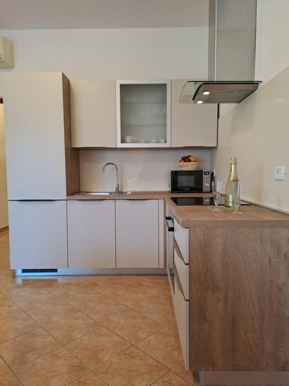 a kitchen with white cabinets and a counter top at Apartment Greta in Kanfanar