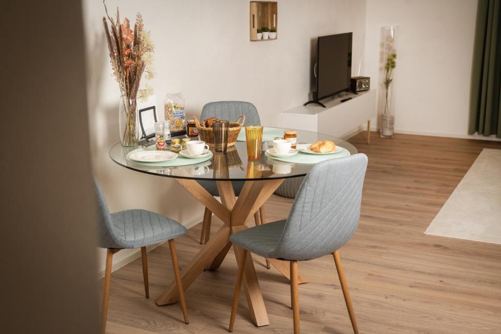 a dining room table with chairs and a table with food on it at Landhaus Oase im Herzen Oberviechtachs in Oberviechtach