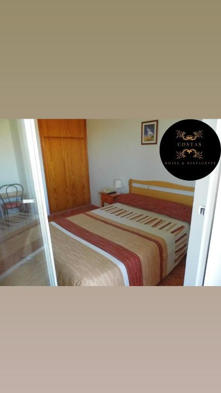 Postel nebo postele na pokoji v ubytování Hotel COSTAS