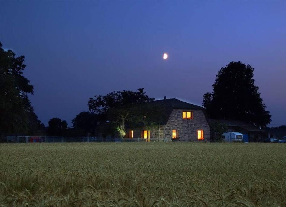 a barn with the moon over a field at night at NiBo Hof - Ruhig und verkehrsgünstig in Goch