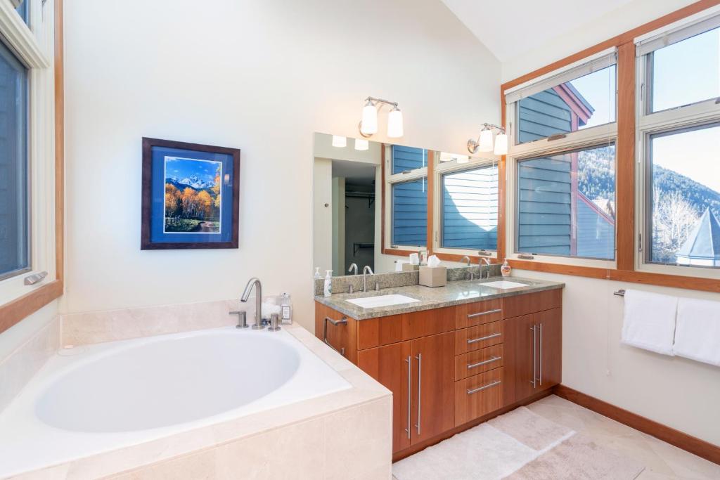 a bathroom with a large tub and a large window at Spacious 3 bedroom Condo Easy walk to Grocery Store and Chairlift 7 in Telluride