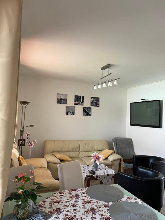 a living room with a couch and a table at Apartmán LOSONCI Nesvady in Nesvady