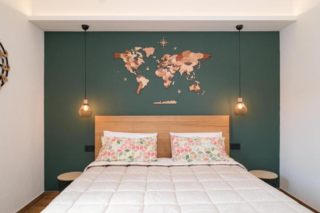 a bedroom with a map of the world on the wall at In centro da Carlotta in Olbia