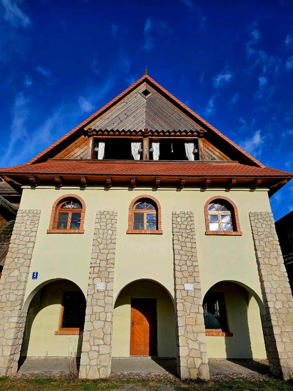 a building with a roof and arches on it at Apartament Singera in Biłgoraj