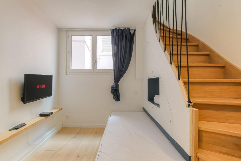 - un escalier dans une maison avec une fenêtre dans l'établissement Cosy et Calme en hypercentre, à Lyon