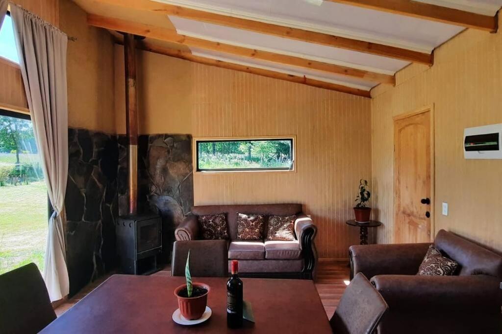 a living room with a couch and a fireplace at Parcela “El Nogal” in Manzanar