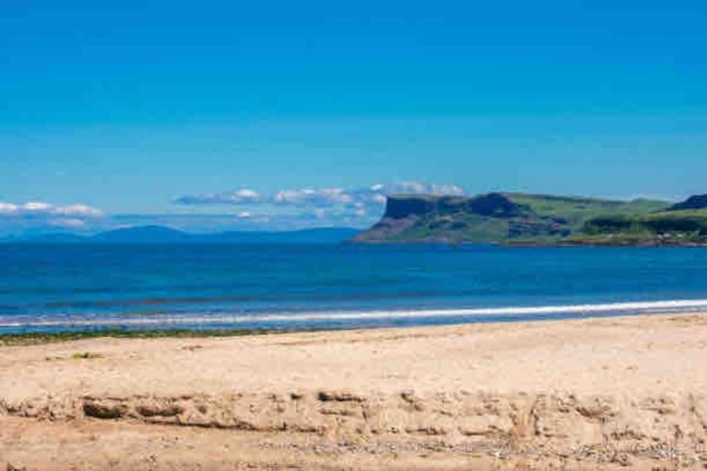 a beach with a view of the ocean at Promenade Sea View Apartment in Ballycastle