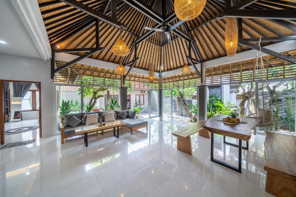a living room with a couch and a table at Villa Orenda 3-bedroom&3-bathroom in Sanur