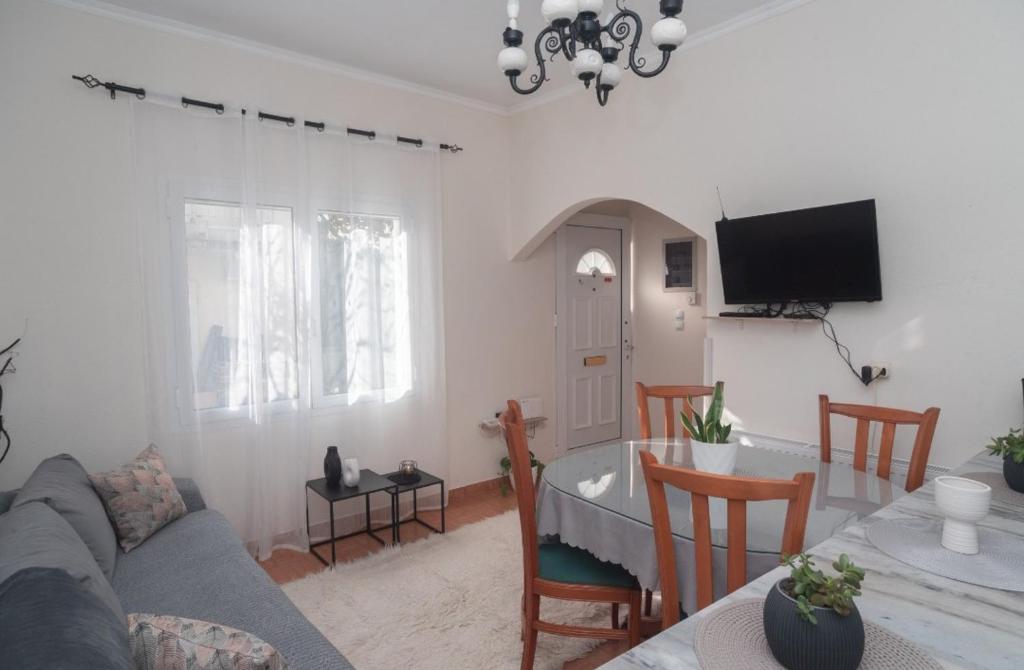 a living room with a couch and a table at Alonaki home 1 in Mesaíon Karlovásion