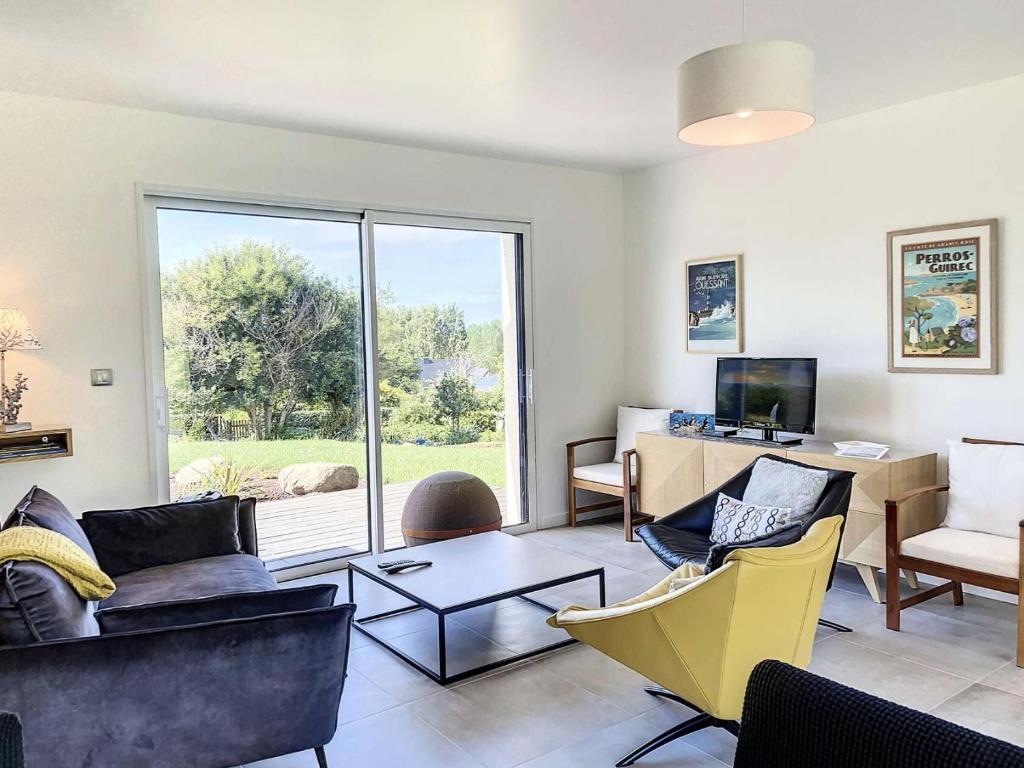 uma sala de estar com um sofá e cadeiras e uma secretária em Résidence L-tregastel - Maisons & Villas 374 em Trégastel