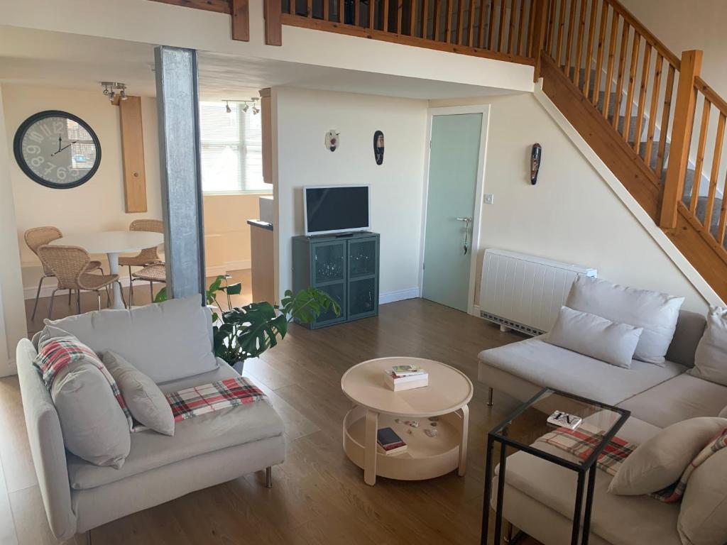 a living room with a couch and a table at Silk Mill Apartment in Macclesfield