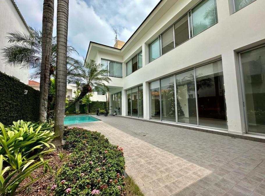 a large building with a palm tree and a courtyard at casa en samborondon in Guayaquil