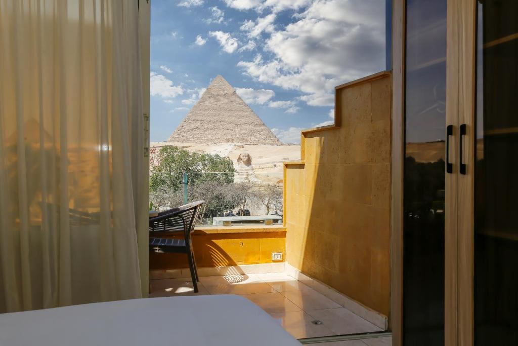 Voodi või voodid majutusasutuse Giza Pyramids View Inn toas