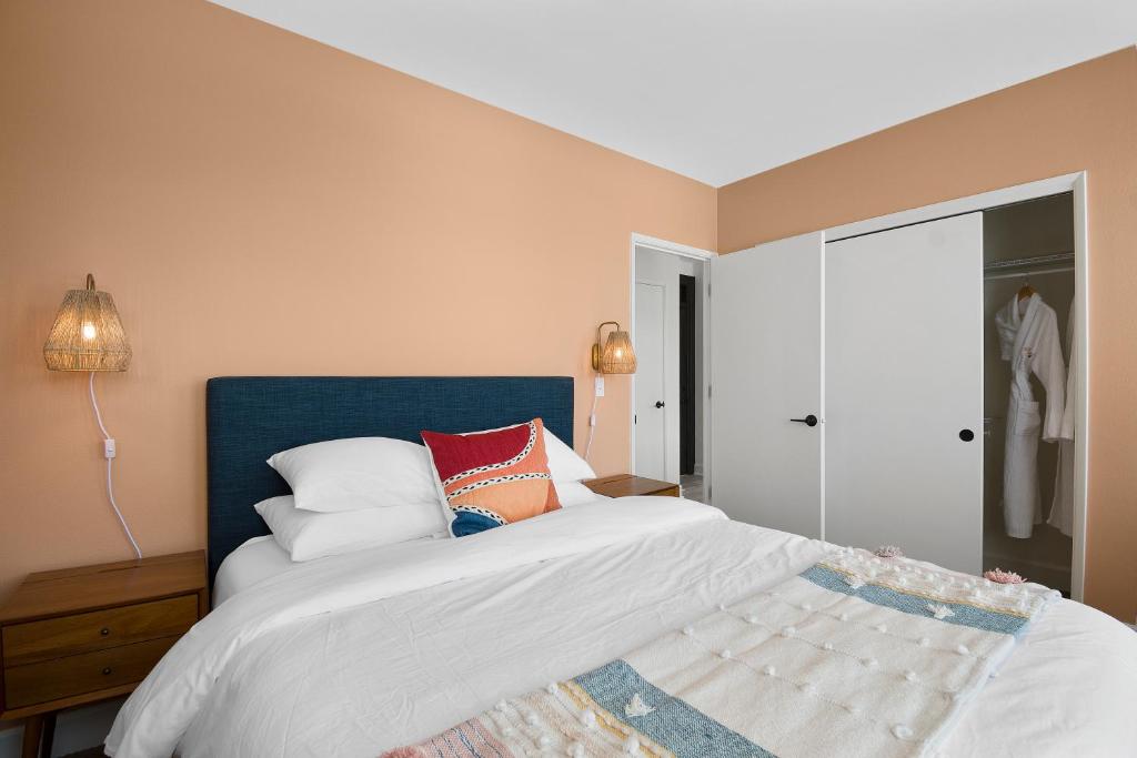 a bedroom with a bed with a blue headboard and pillows at Norblad Hotel in Astoria, Oregon