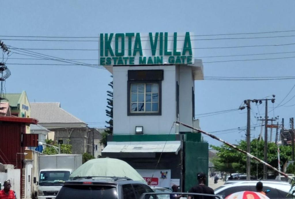 a sign for a koko villa salt man club on a building at Pentagon Court Phase 1 Apartment Ikota in Lagos