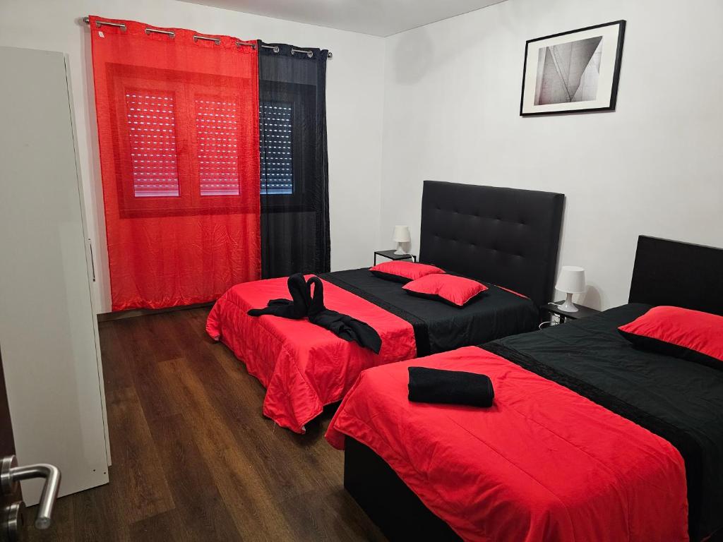 2 camas en una habitación con rojo y negro en Reis Apartment en Oporto