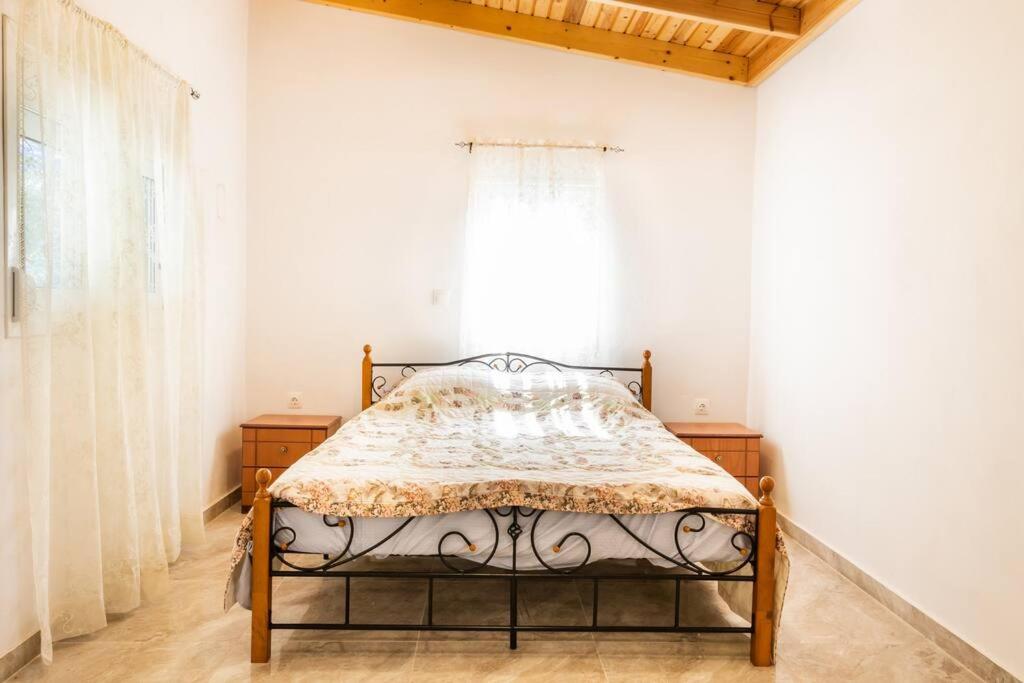 a bed in a room with a window at Villa Lothiko in Karpathos Town